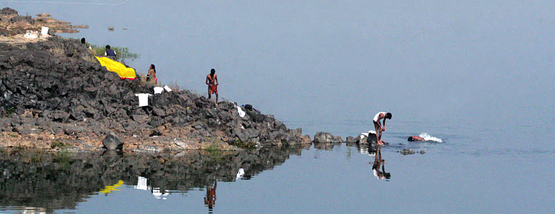 People doing washing in holy river Narmada