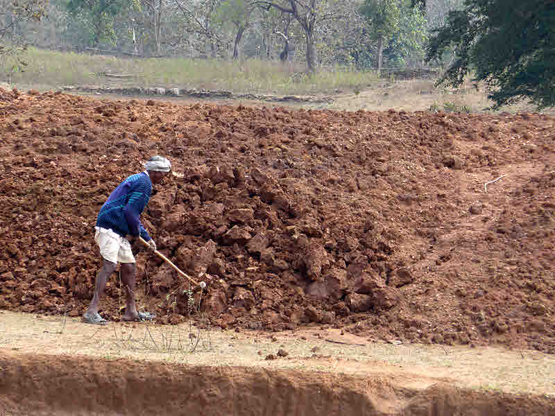 Earthen dam being built by hand